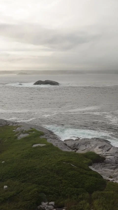 Vertical Aerial View Powerful Ocean Waves Hitting Rocky Coast In Nova Scotia Stock Footage 313688358