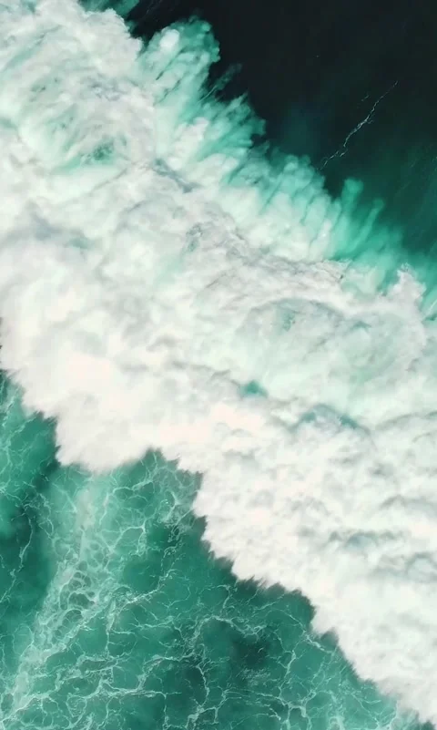 Vertical Aerial View of Powerful Ocean Waves Crashing and Creating Sea Foam Stock Footage 337738124