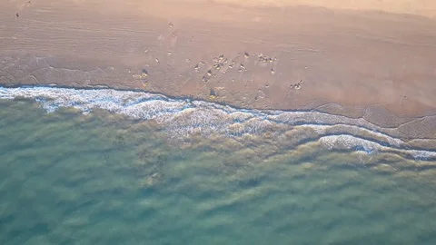 Vertical aerial view of pristine beach and turquoise ocean water Stock Footage 115609793