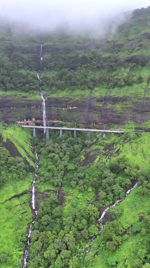 Vertical Aerial View of Railway Bridge and Waterfalls in Maharashtra Video stock 335014707