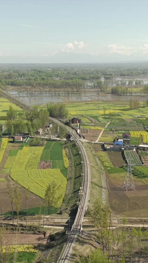 Vertical Aerial View of Railway Track Through Farmland in Pampore Kashmir India Stock Footage 334180792