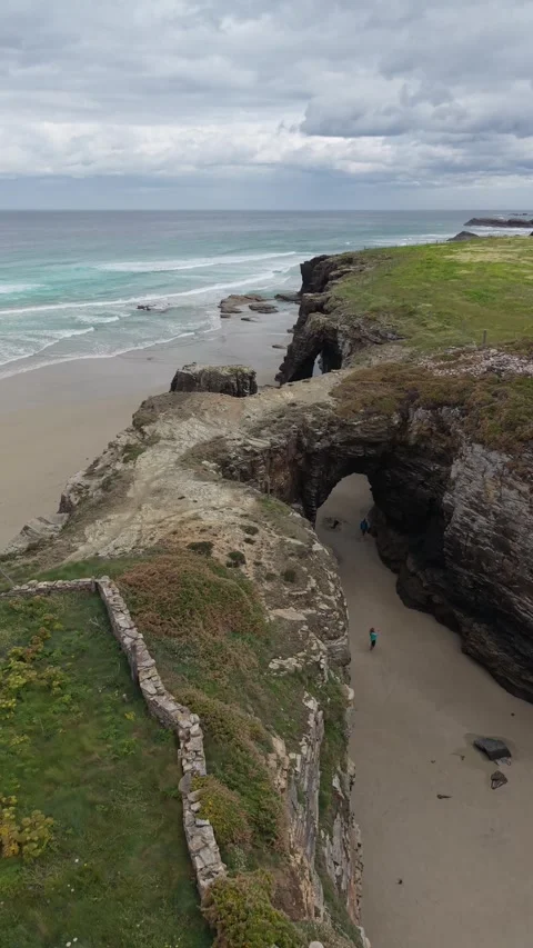 Vertical aerial view of a rock arch on a tidal beach Stockbeeldmateriaal 343324028