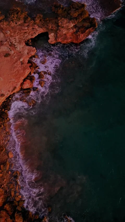 Vertical Aerial View of Rugged Rocky Coastline and Crashing Waves Stock Footage 337736046