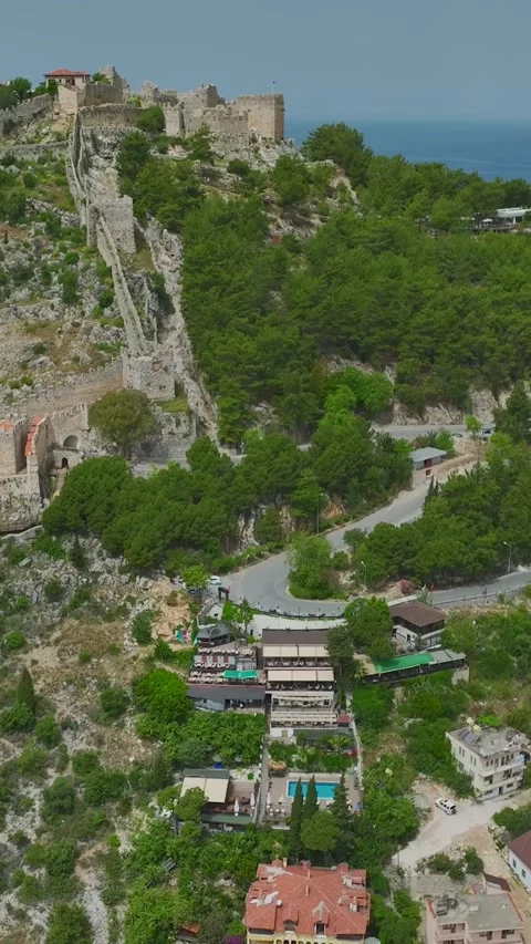 Vertical Aerial View Runners Training Near Ancient Fortress Walls by the Sea Video stock 341781855