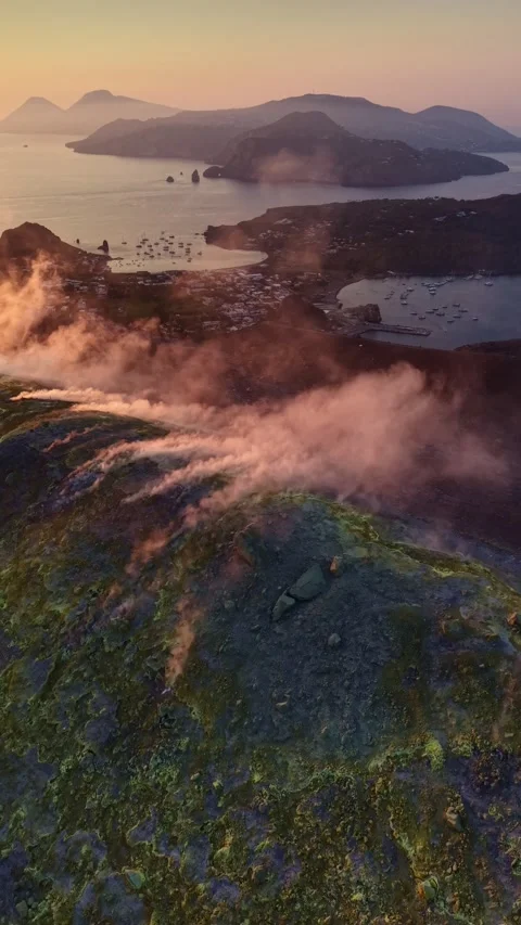 Vertical aerial view showcases steaming fumaroles on Vulcano island at sunset Stock Footage 341755248