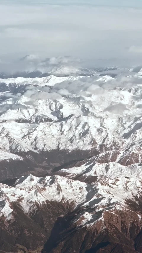 Vertical Aerial view of the snow capped Alps, rugged mountain peaks landscape. Stock Footage 313007903