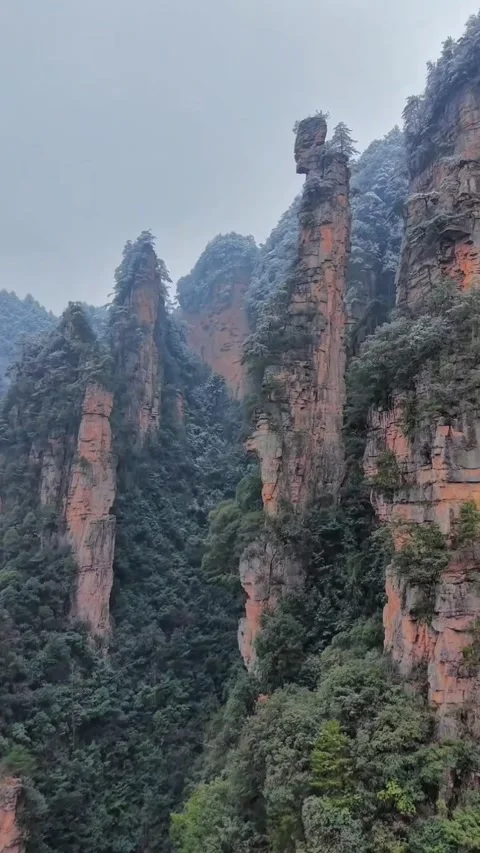 Vertical Aerial View of Snow-Covered Sandstone Peaks in Zhangjiajie Stock-Footage 330147187