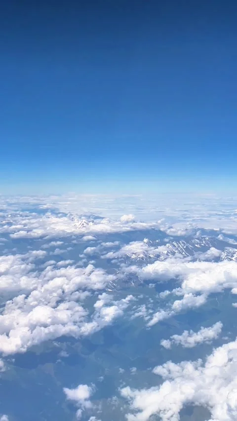 Vertical Aerial View of Snowy Mountain Peaks Above Clouds Stock-Footage 330936032