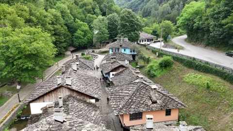 Vertical aerial view of stone-roofed houses in a historic Bulgarian village. Stock Footage 327670492