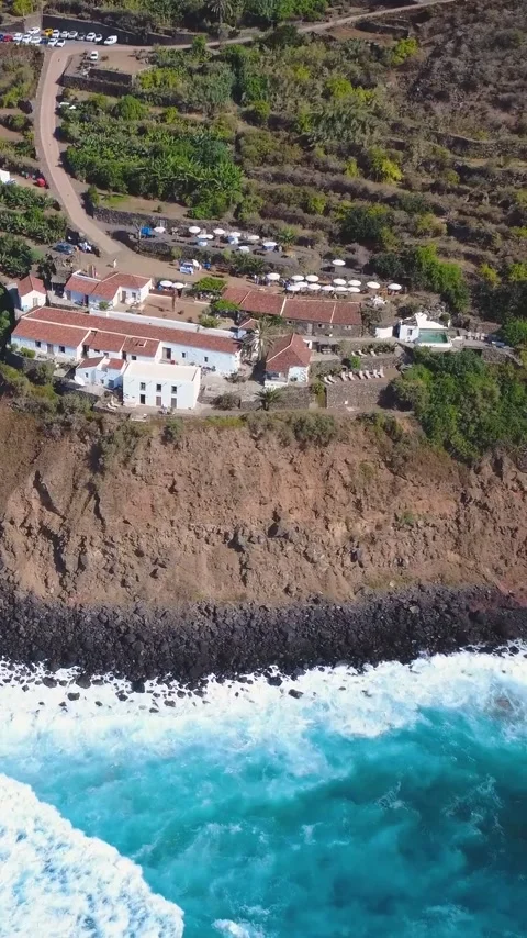 Vertical Aerial View of Turquoise Surf on a Volcanic Coastline in Tenerife Stock Footage 344851134