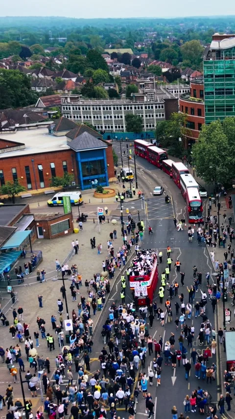 Vertical aerial view of victory parade with open top bus and crowd Stock Footage 335118778