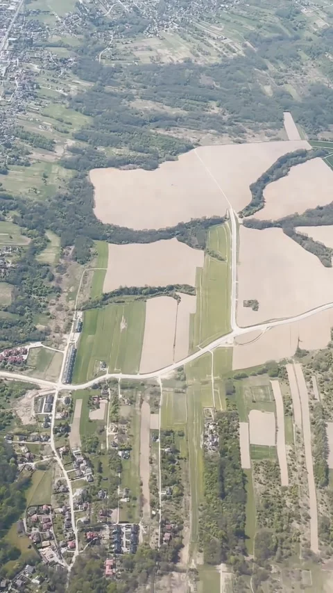 Vertical aerial view of a village, patchwork farmland, forest strips and Stock Footage 338003982