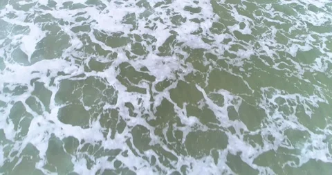 Vertical aerial view of waves breaking. The Concept of Energy. Stock Footage 325907825