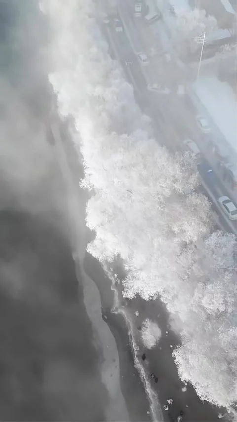 Vertical Aerial View of White SUV Driving on Snowy Mountain Road Stock Footage 327997695