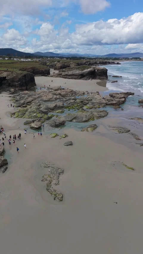 Vertical aerial view of a wide tidal beach and rocks Stockbeeldmateriaal 343324111