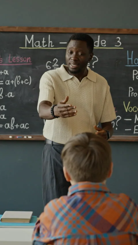Vertical of African American Teacher Explaining Math Lesson to School Students Stock Footage 340547153