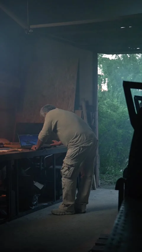 Vertical of Aged man makes measurements of future aircraft in garage Stock Footage 275621300