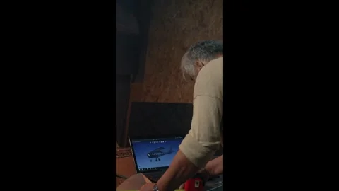 Vertical of Aged man makes measurements of own future plane in garage Stock Footage 275624500