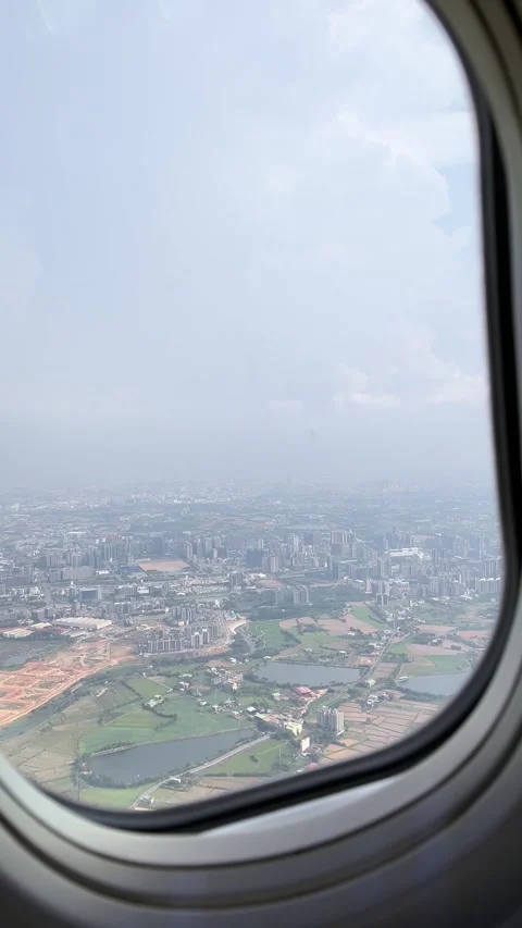 (Vertical) Airplane Window View of Taiwan After Takeoff from Taoyuan Airport Stock Footage 341750357