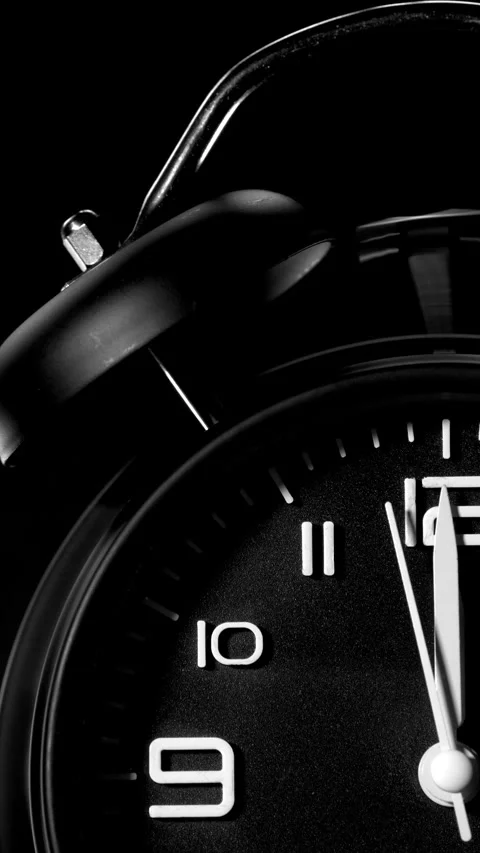 Vertical - Analog black alarm clock, with bell ringing at 12 o’clock. Stock Footage 281505236