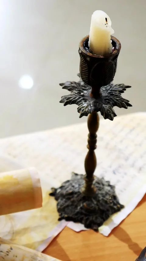 Vertical. Ancient parchment, bound by time. Aged scrolls and candles. Stock Footage 305160226