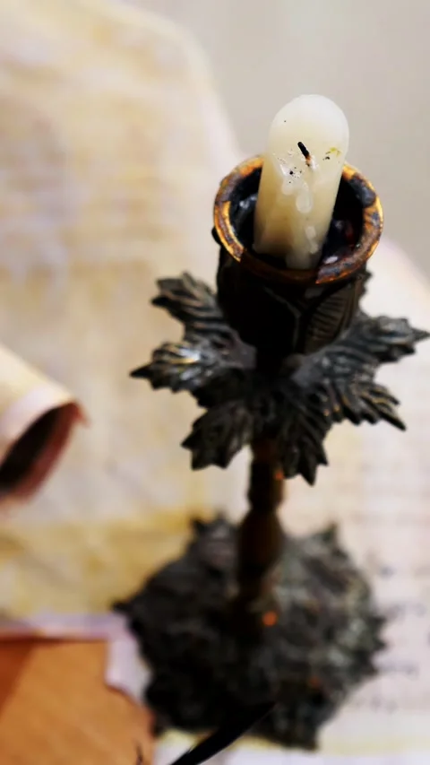 Vertical. Ancient parchment, bound by time. Aged scrolls and candles. Stock Footage 305160830