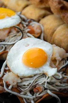 Vertical and zenithal macro view of puff pastry with gluttony, quail egg and  Stock Photos