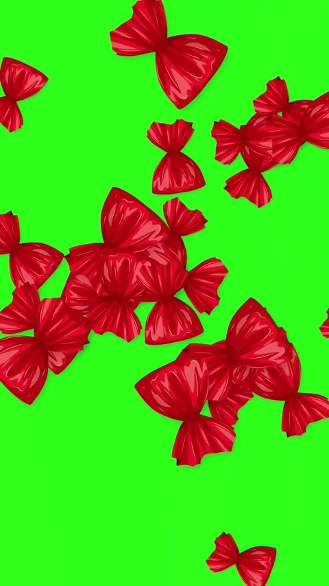 Vertical Animation of Red Wrapped Candies Falling on Green Background Stock Footage 344831341