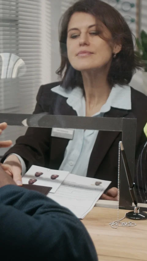 Vertical of Anonymous Black Businessman Submitting Documents for Visa 스톡 동영상 331520854