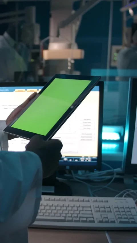 Vertical of Anonymous black doctor reading data from tablet in lab Stock Footage 276874459