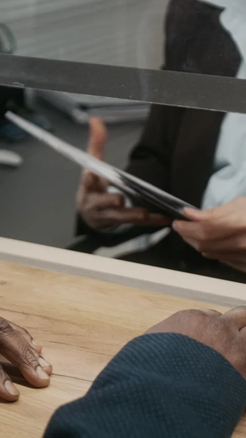 Vertical of Anonymous Black Man Submitting Paperwork at Visa Center Stock Footage 331520494