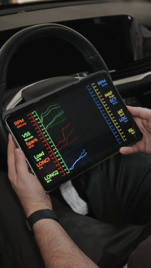 Vertical of Anonymous Mechanic with Tablet Running Engine Efficiency Test Stock Footage 329462363