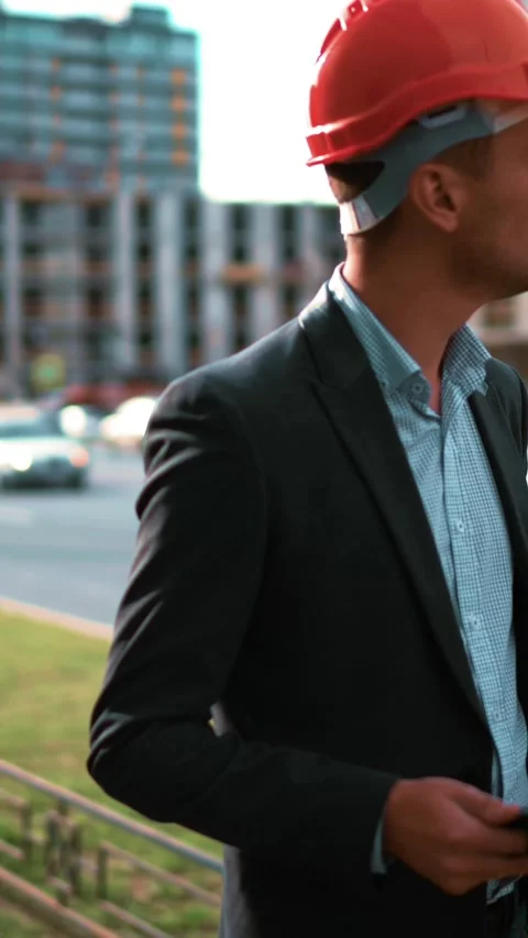 Vertical of Architect looking tablet pc and comparing project with building Stock Footage 305519433