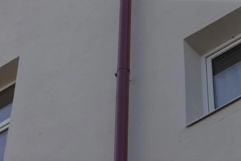 Vertical architectural elements and smooth stucco on building facade Stock Photos