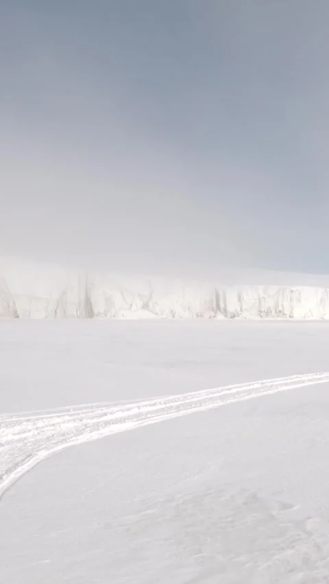 Vertical Arctic Snow Plain in the Interior of Svalbard With Snowmobile Tracks Stock Footage 340036119