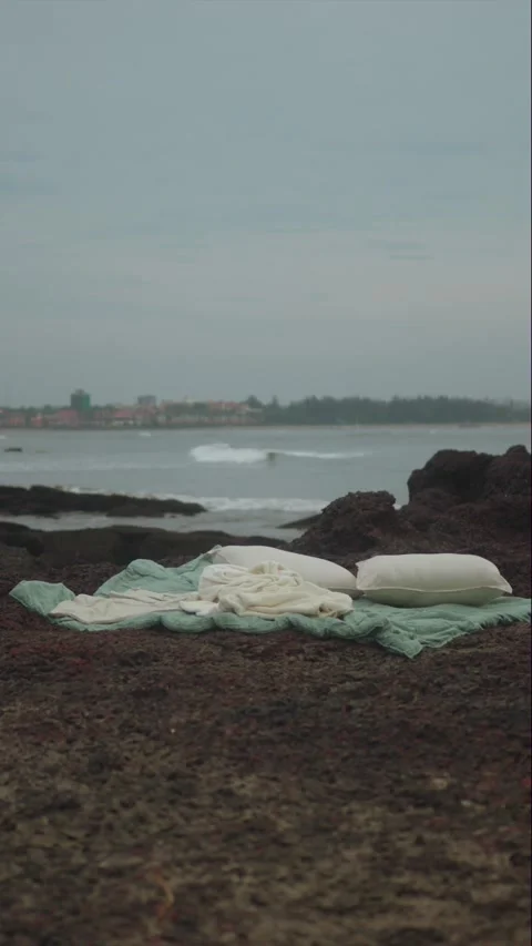 Vertical artistic composition of soft bedding and pillows placed on a rocky Stock Footage 330964812