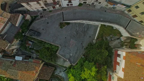 Vertical ascent from the square of the small medieval village of Roccacasale Stock Footage 206691491