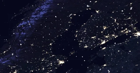 Vertical ascent through light falling snow, over Scandinavia, at night. Video stock 99432114