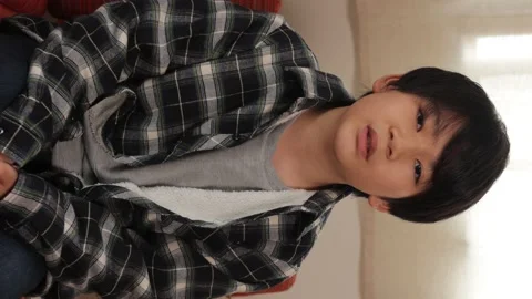 Vertical : Asian boy introduces himself to the camera. 25P. Stock Footage 221355688