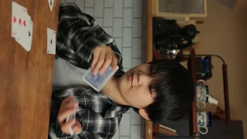 Vertical : Asian boy playing cards at home. Speed Card. Stock Footage 224079161