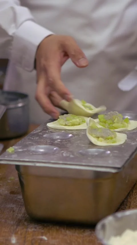 Vertical Asian man making fresh dumplings in a kitchen restaurant of Taiwan Stock Footage 311423684