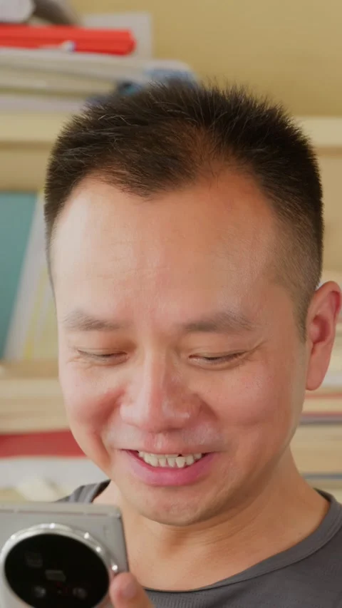 Vertical  Asian man reading meme and entertainment on social media Stock Footage 342472187