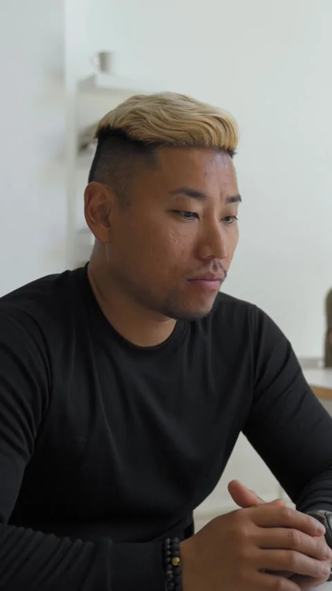 Vertical of Asian man waves hello to camera talking with new client Stock Footage 276627496