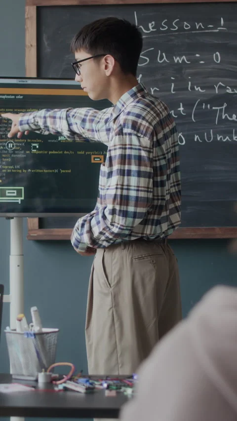 Vertical of Asian Student Discussing Software Engineering with Teacher in Class Stock Footage 284921486