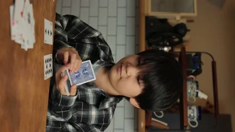 Vertical : Asian young boy playing cards at home. Speed Card. Stock Footage 221397779