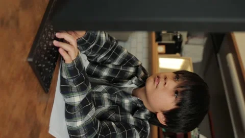 Vertical : Asian young boy studying in front of computer monitor. Stock Footage 221360840
