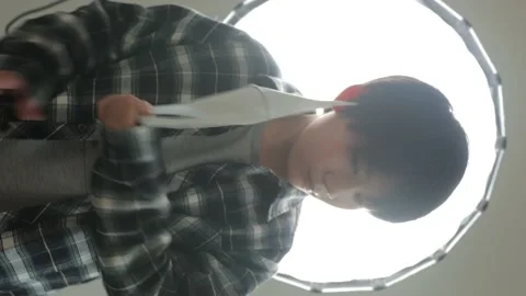 Vertical : Asian young boy takes his mask off and stares the camera. Stock Footage 221380422
