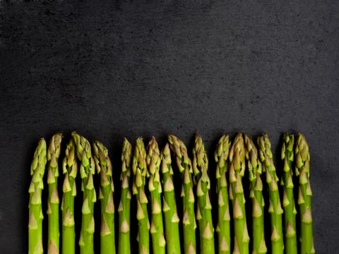 Vertical Asparagus on charcoal Slate base Stock Photos
