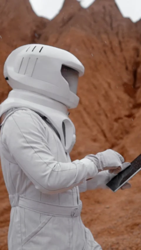 Vertical of Astronaut working with digital pad on the Mars surface Stock Footage 275621419