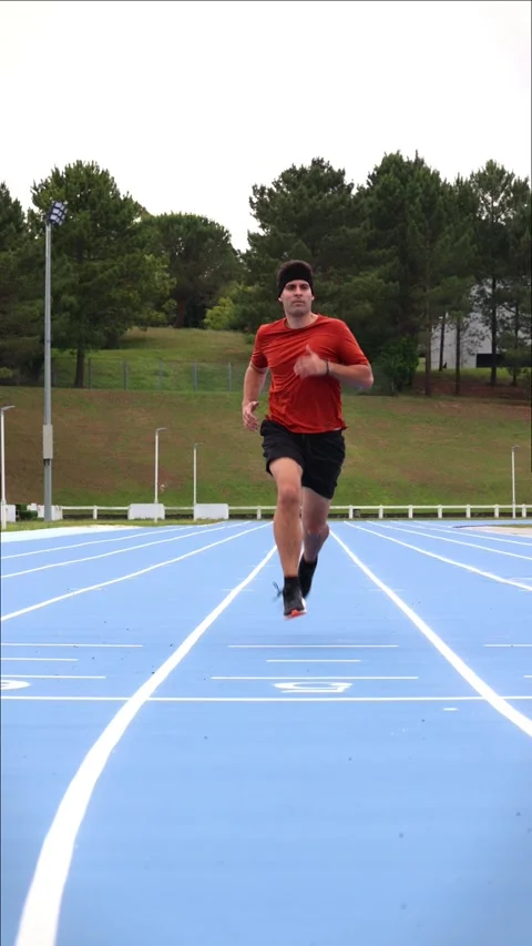 Vertical Athlete Runner with Headband Sprints During Outdoor Training on At.. Stock-Footage 277500906